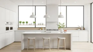 Modern white kitchen with island, pendant lights, and natural light