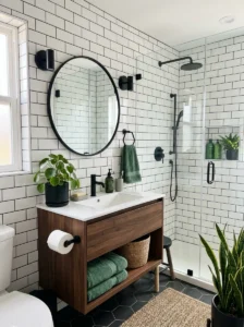 White subway tile bathroom with dark grout and green decor accents