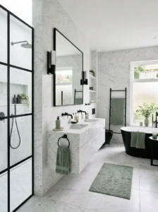 Marble bathroom with sage green accents and black fixtures