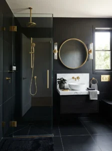 Black tile bathroom with gold fixtures