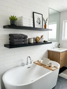 Black floating shelves in bathroom adding storage and clean design