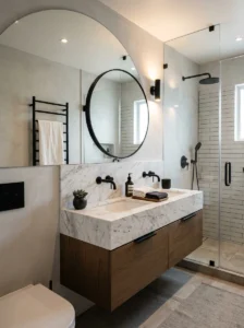 Modern bathroom with matte black hardware, marble surfaces, and sleek minimalist styling