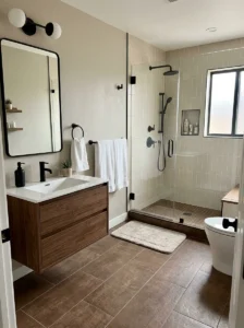 Brown tile bathroom floor with black fixtures design