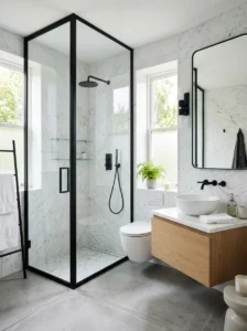 Black framed shower glass adding structure to modern bathroom