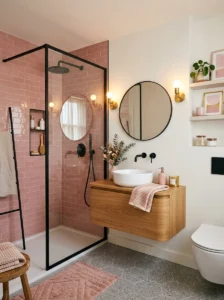 Pink shower tiles with black framed shower glass