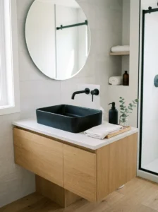 Black sink as a statement piece in a clean modern bathroom