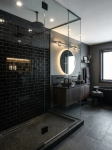Glossy black subway tile shower reflecting light in modern bathroom