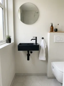 Compact black sink adding style to a small modern bathroom