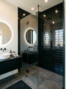 Glossy black tiles reflecting light for a clean and modern bathroom look