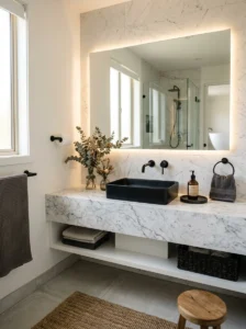 Modern bathroom with black sink, marble countertop, and warm minimalist decor