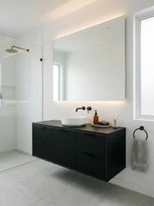 Minimalist black vanity cabinet in a modern bathroom