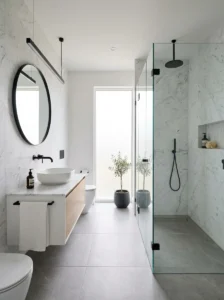 Minimalist black and white marble bathroom with frameless shower