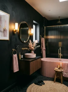 Moody pink bathroom with black walls and warm lighting