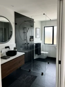 Open black shower with frameless glass creating an airy modern look