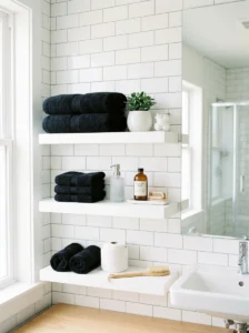 Black towels on white shelves bathroom decor